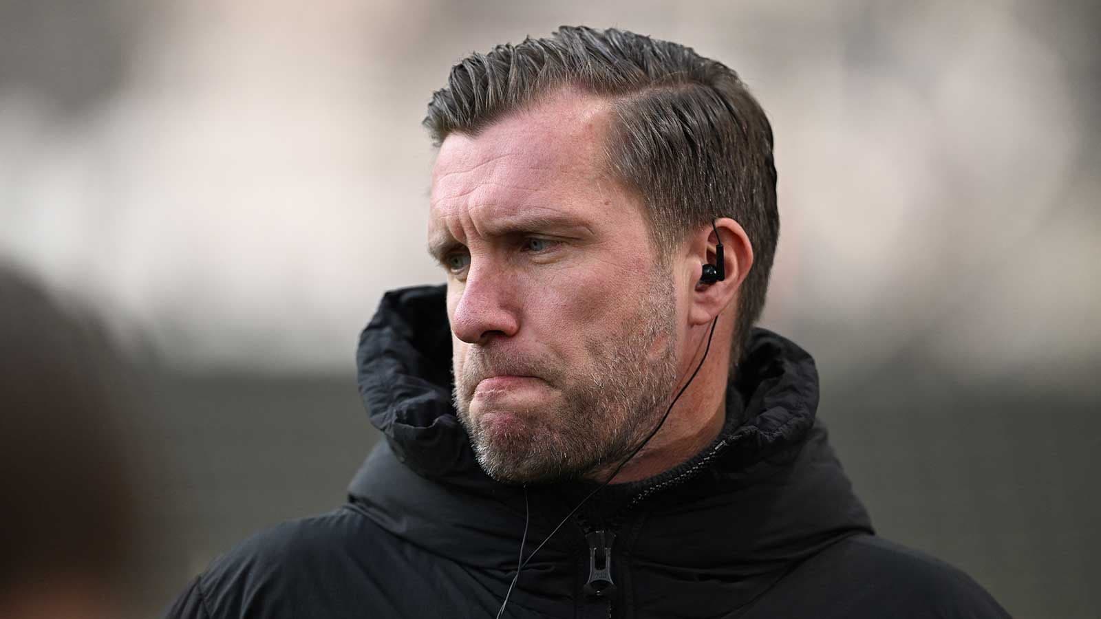 Coach listening intently during training session