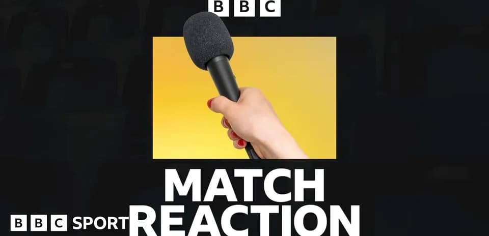 Hand holding a microphone for match reaction