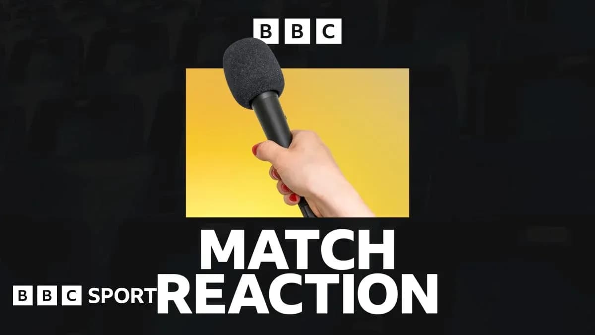 Hand holding a microphone for match reaction