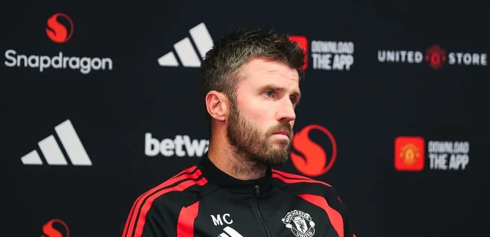 Manager speaking at press conference with Manchester United branding