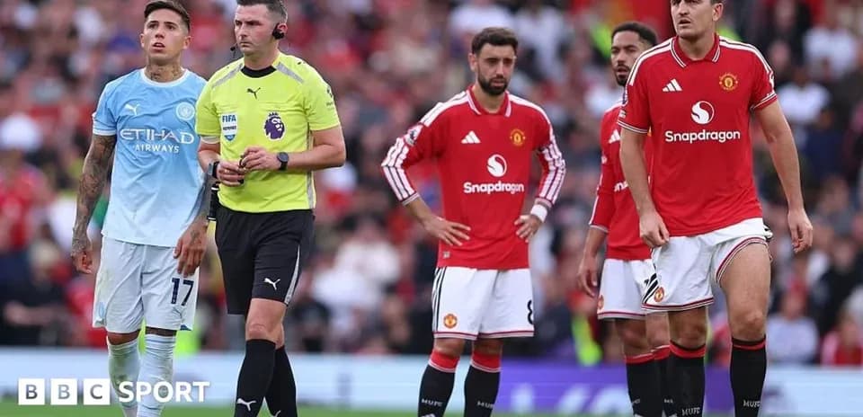 Players from Manchester United and referee during match