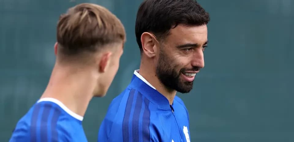 Two football players talking during training session