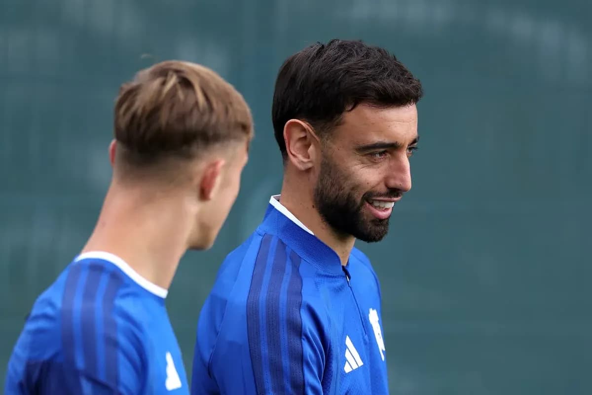 Two football players talking during training session