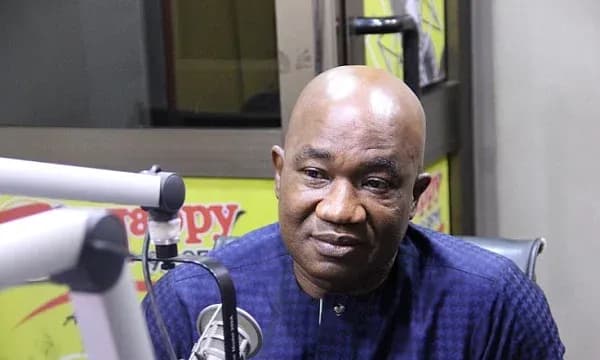 Man speaking in radio studio with microphone