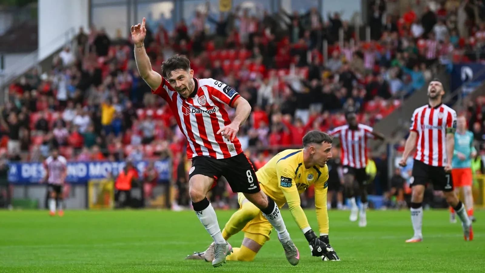 Player celebrating a goal with fans in background