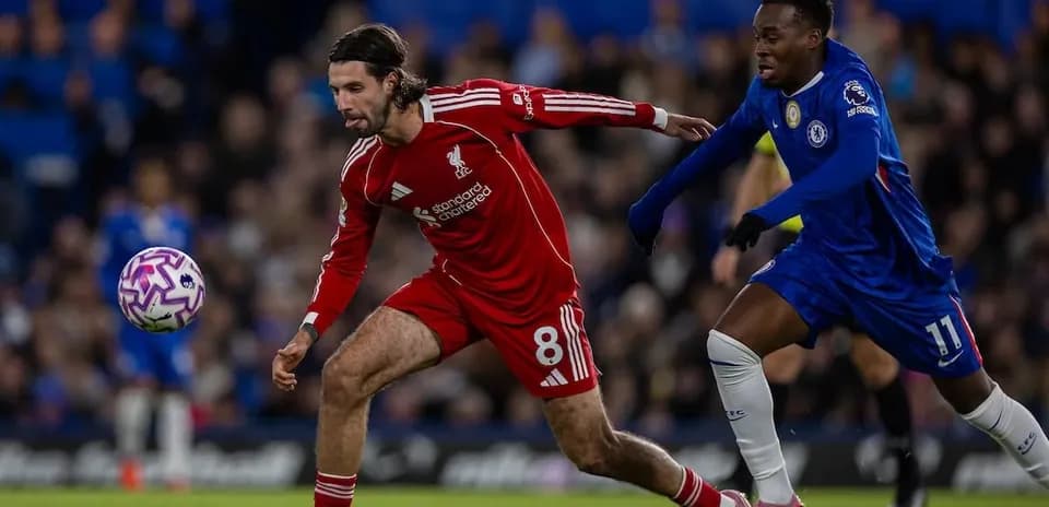 Liverpool player competing for the ball against Chelsea