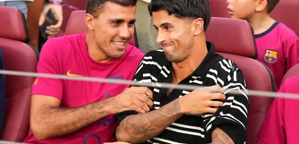 Two players seated together at a stadium