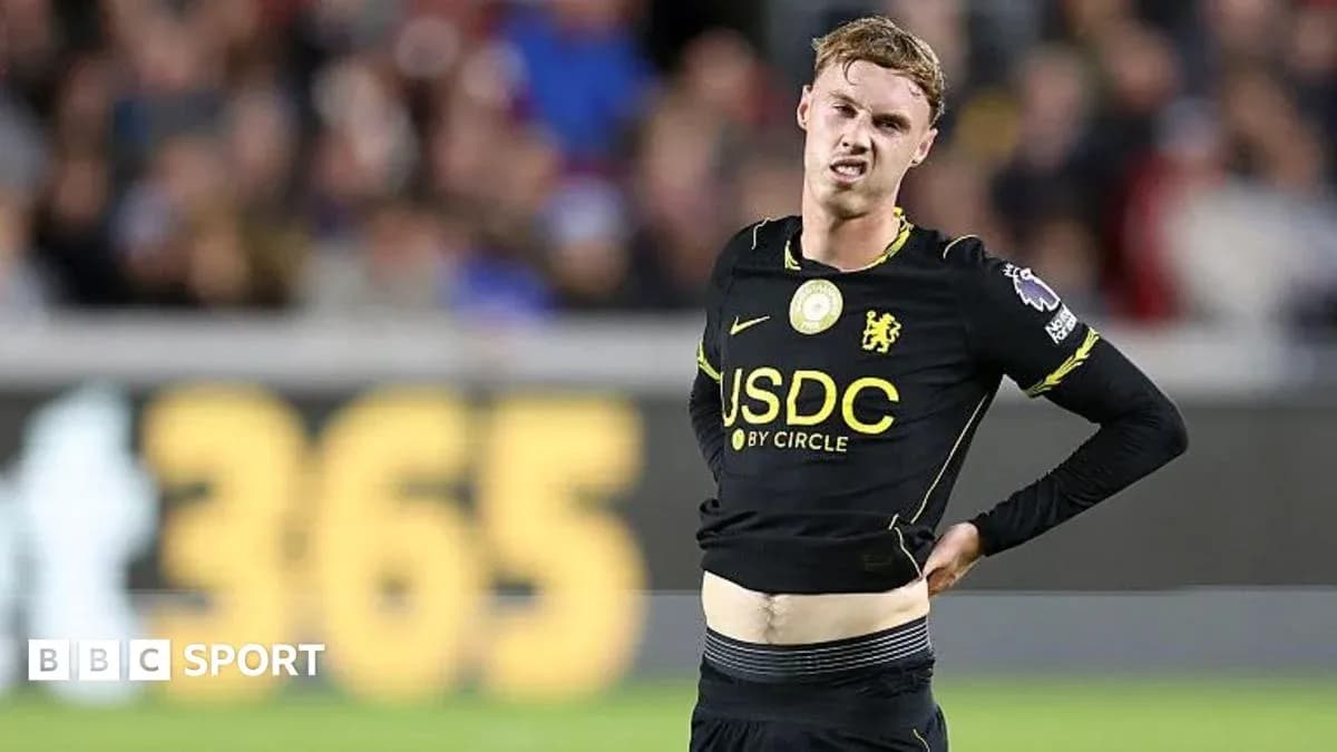 Player adjusting shirt during football match