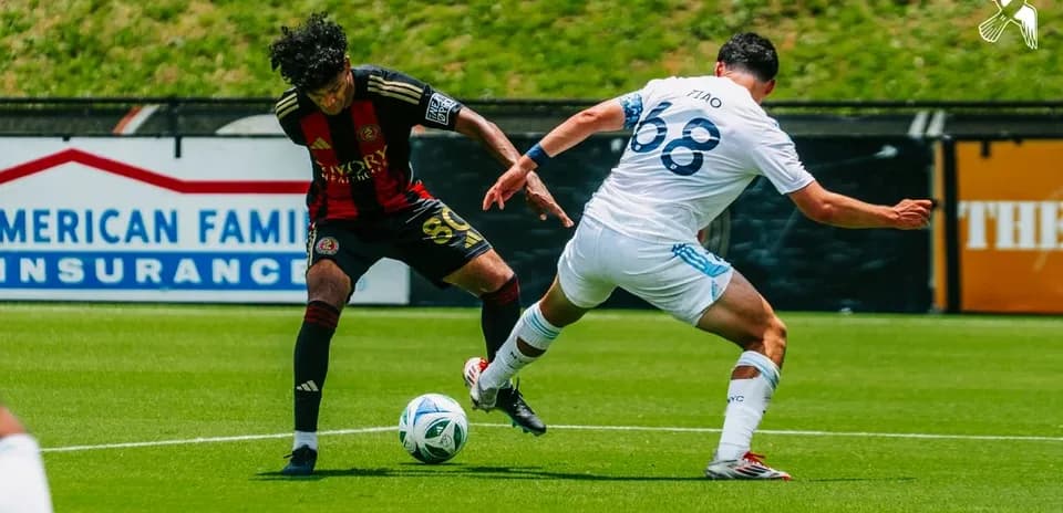 Atlanta United II player tackling New York City II opponent
