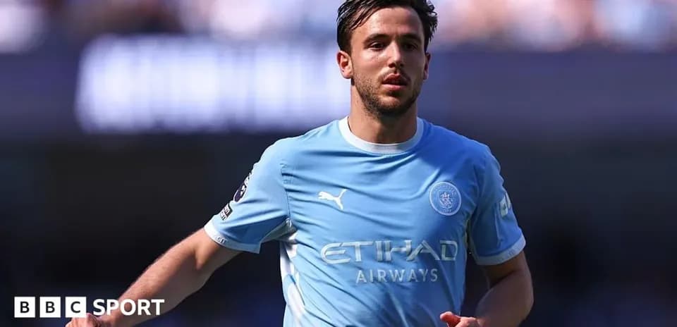 Player in light blue kit running on the field