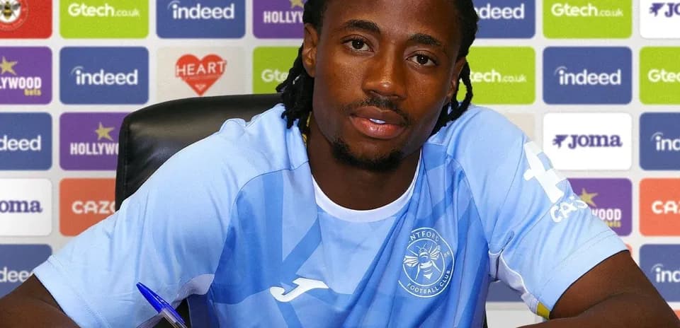 Player signing contract at press conference table