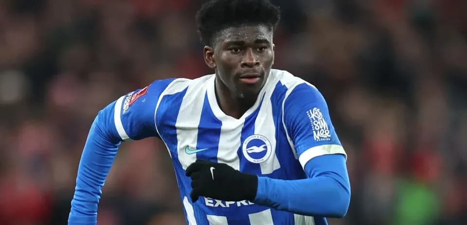 Player running during match in Brighton kit