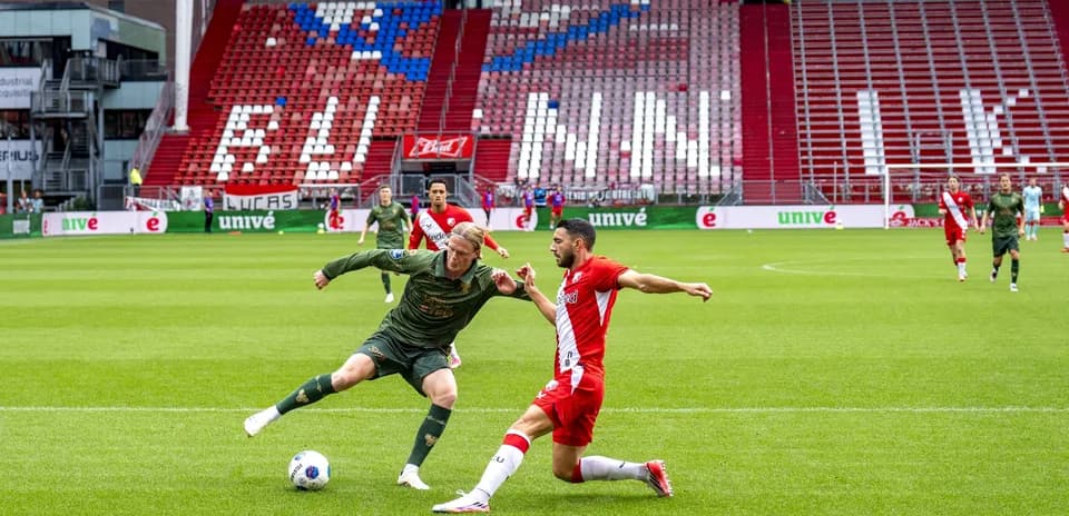 Two players competing for the ball during match