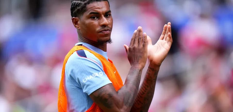 Player clapping while wearing training bib on sidelines