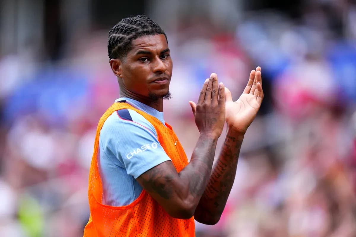 Player clapping while wearing training bib on sidelines Player clapping while wearing training bib on sidelines