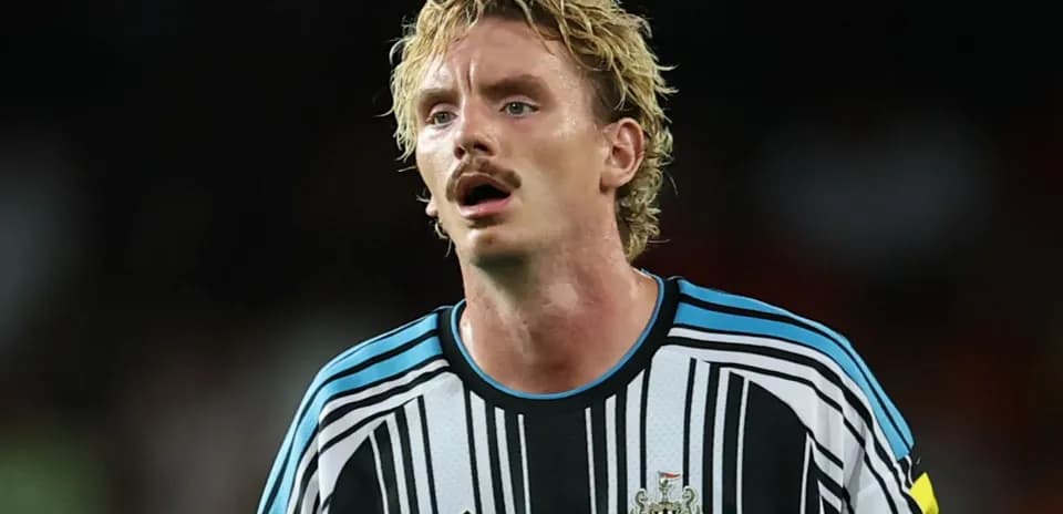 Newcastle United player in black and white jersey