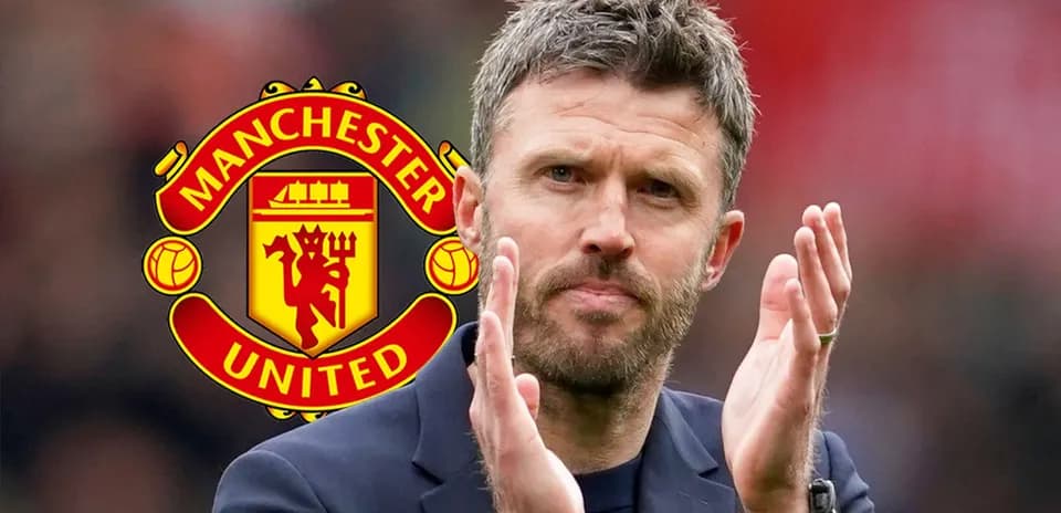 Coach applauding with Manchester United logo in background