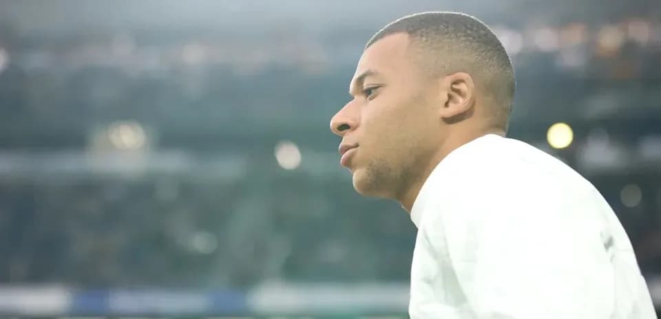 Player observing from sidelines during match warm-up