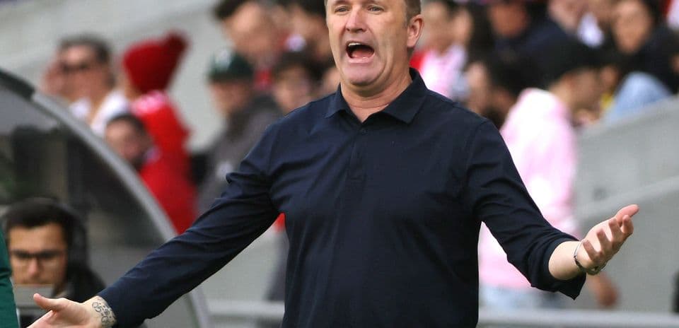 Coach gesturing animatedly during a match