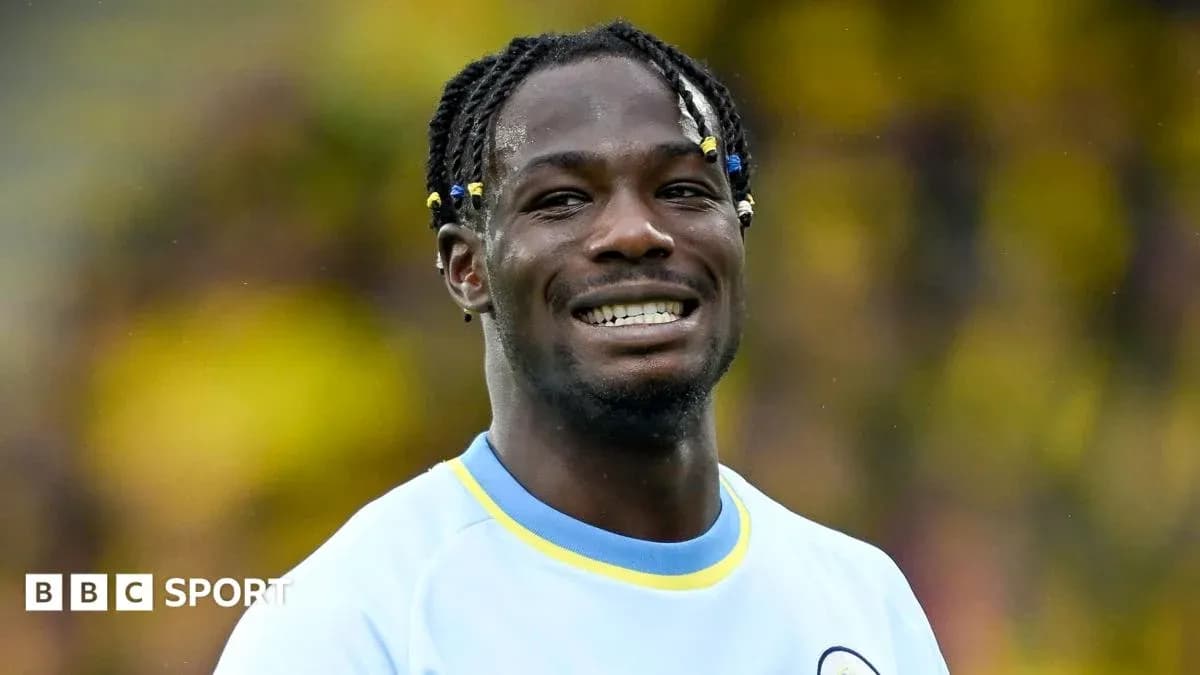 Player smiling while wearing team jersey on field