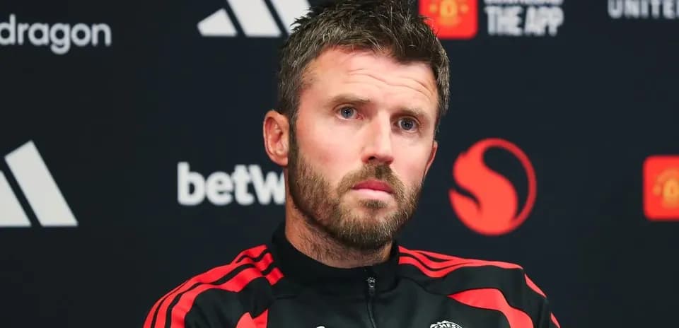 Manager speaking at press conference with Manchester United branding