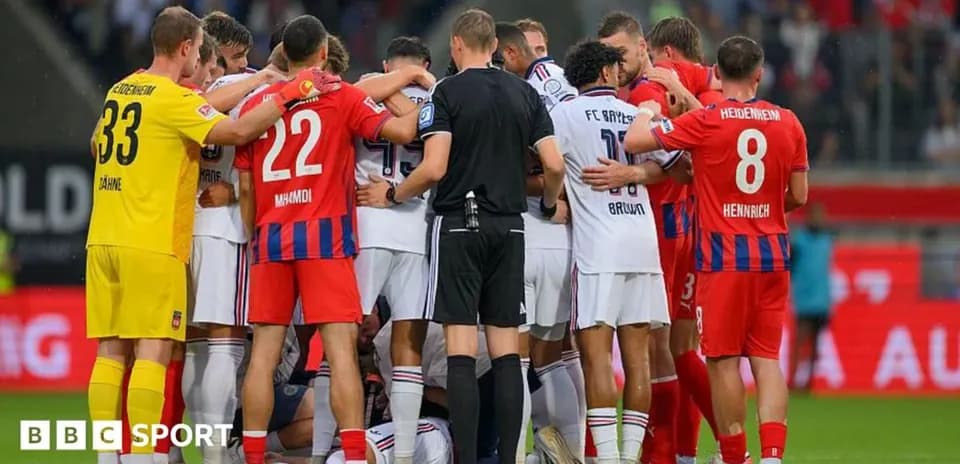 Players from both teams gathered around injured player