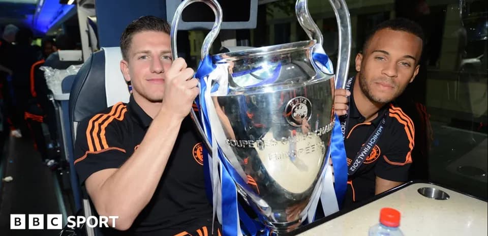 Two players celebrating with UEFA Champions League trophy