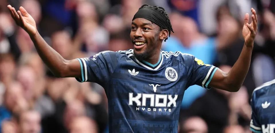 Player celebrating with fans after scoring goal