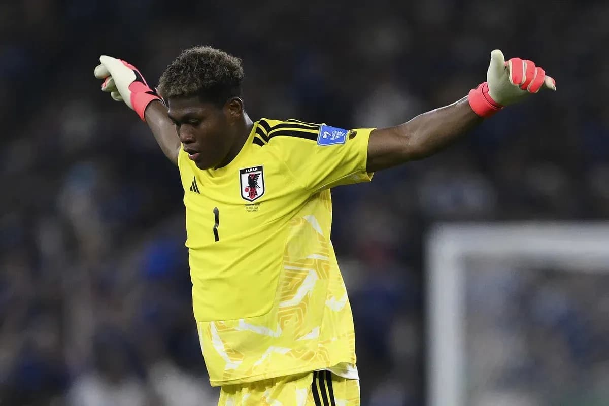 Goalkeeper in yellow kit celebrating a save