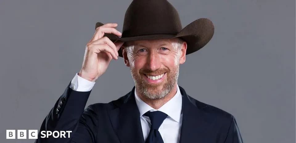 Man in suit tipping cowboy hat and smiling