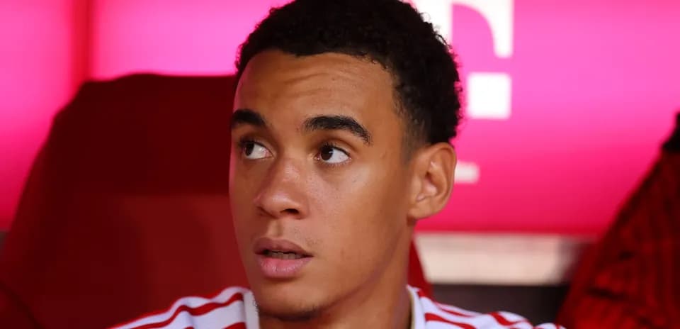Player sitting on bench with focused expression