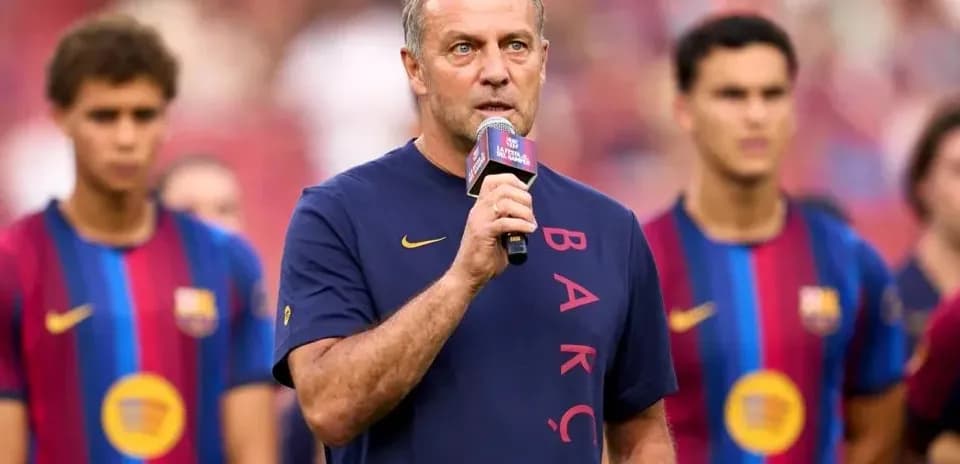 Manager speaking at event with players behind