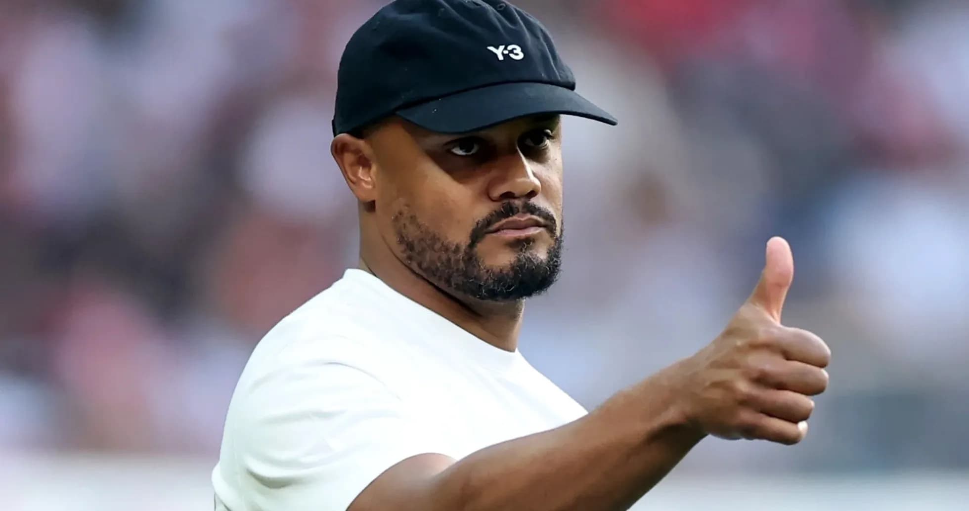 Man in a cap giving a thumbs up gesture