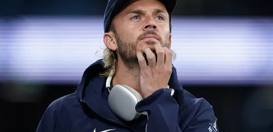 Man in sportswear looking thoughtfully at the field