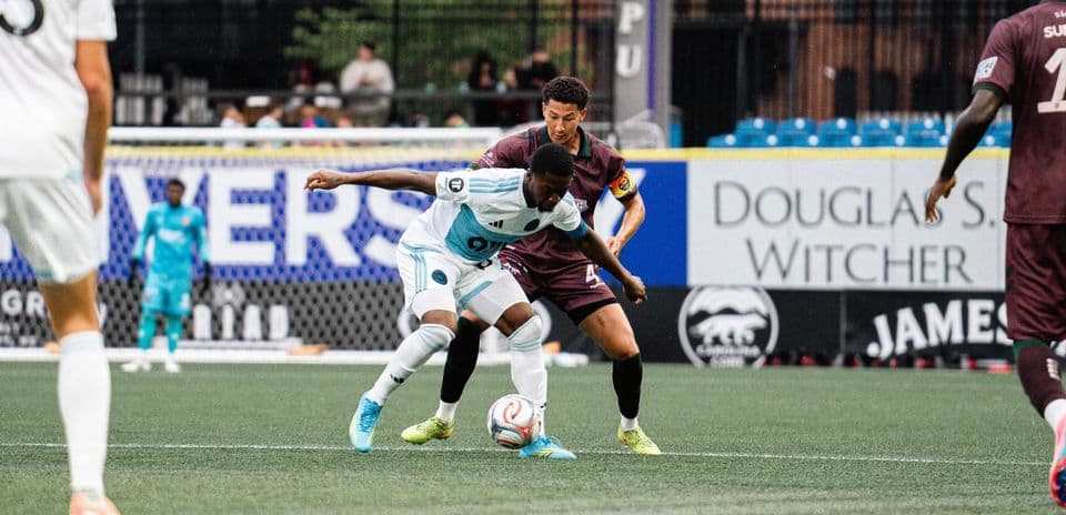 Players battling for the ball during match