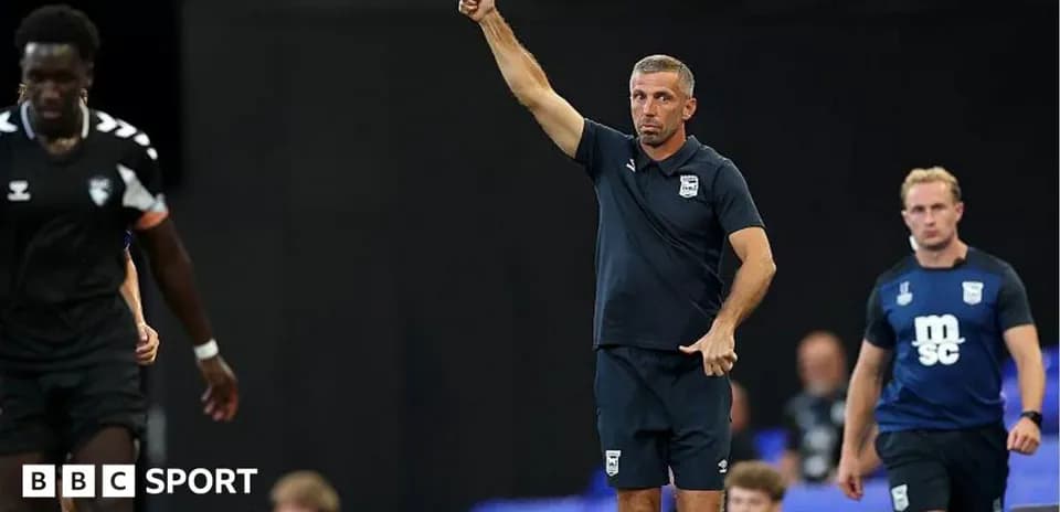 Coach signaling during a football match on sidelines