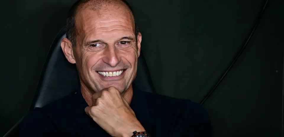 Coach smiling while sitting in a chair