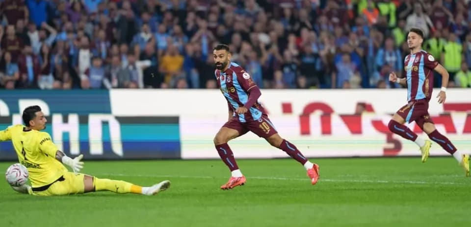 Player scoring against goalkeeper in football match
