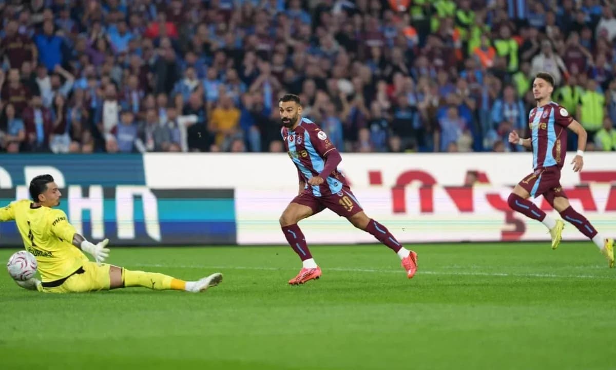Player scoring against goalkeeper in football match