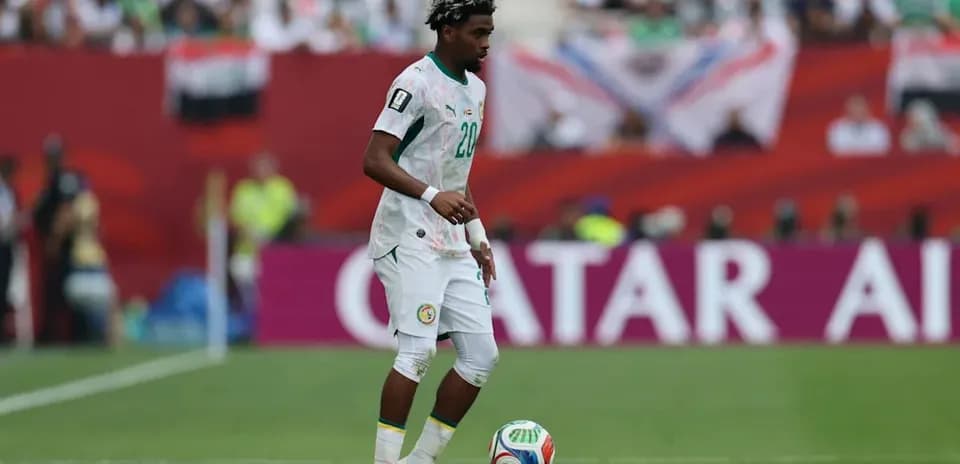 Player in Senegal kit controlling the soccer ball