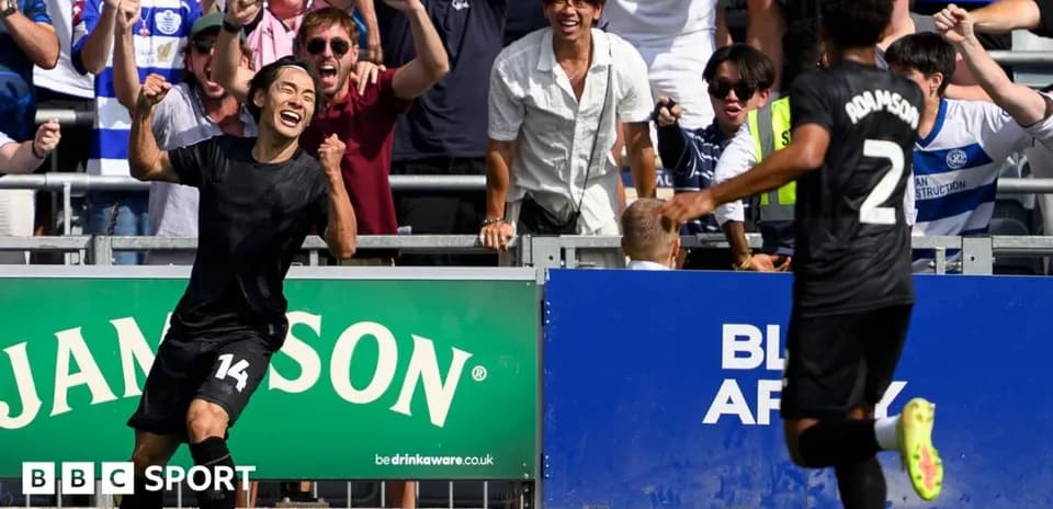 Player celebrating a goal with fans in background