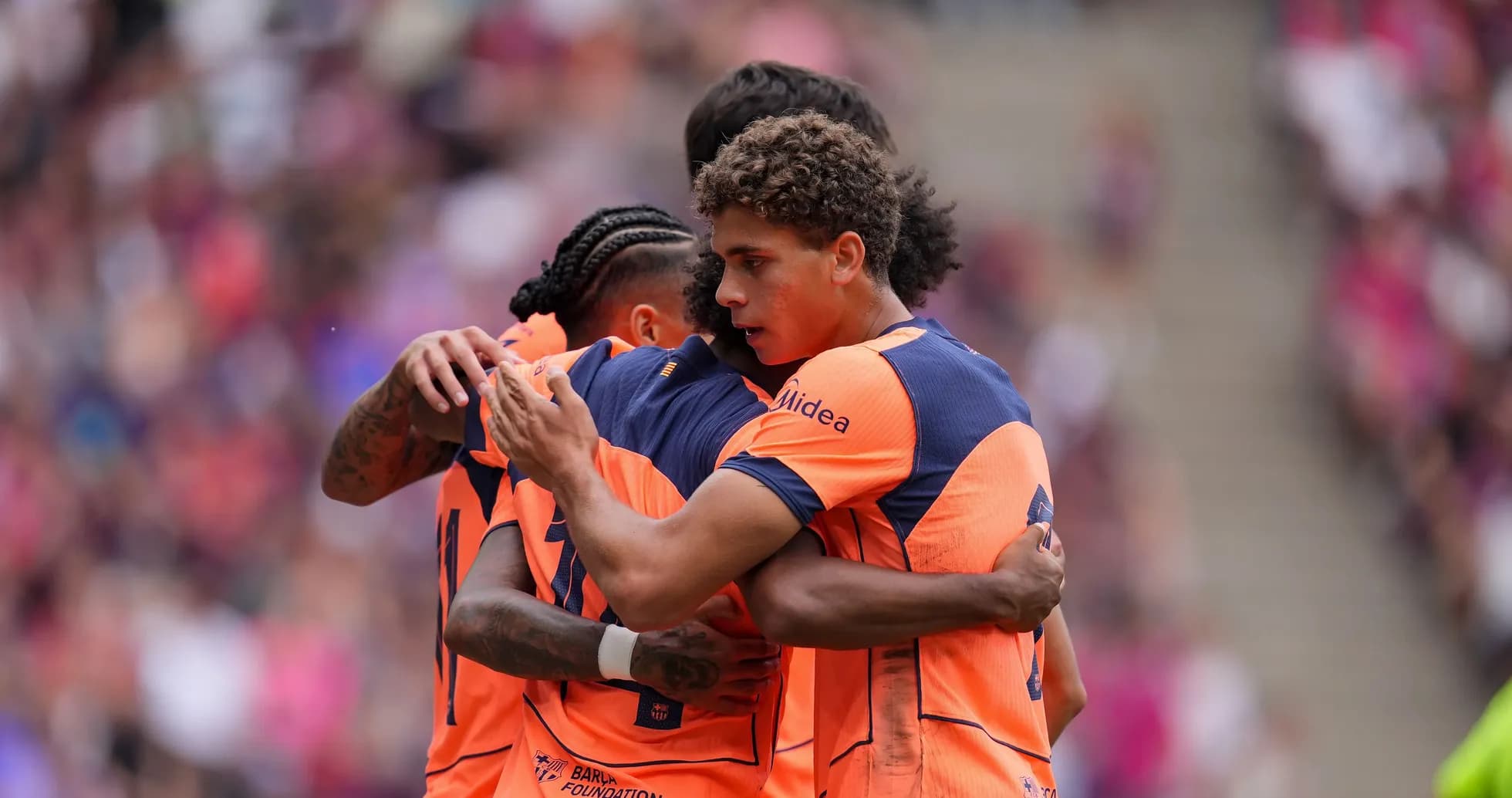 Players celebrating a goal in team jerseys
