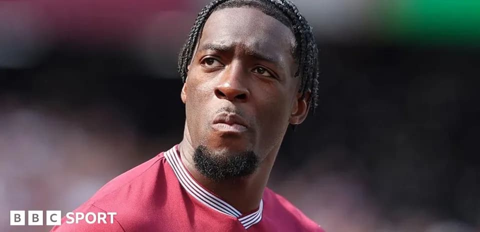 Player wearing maroon jersey during match warm-up