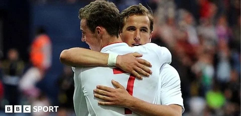 Two players embracing during a football match