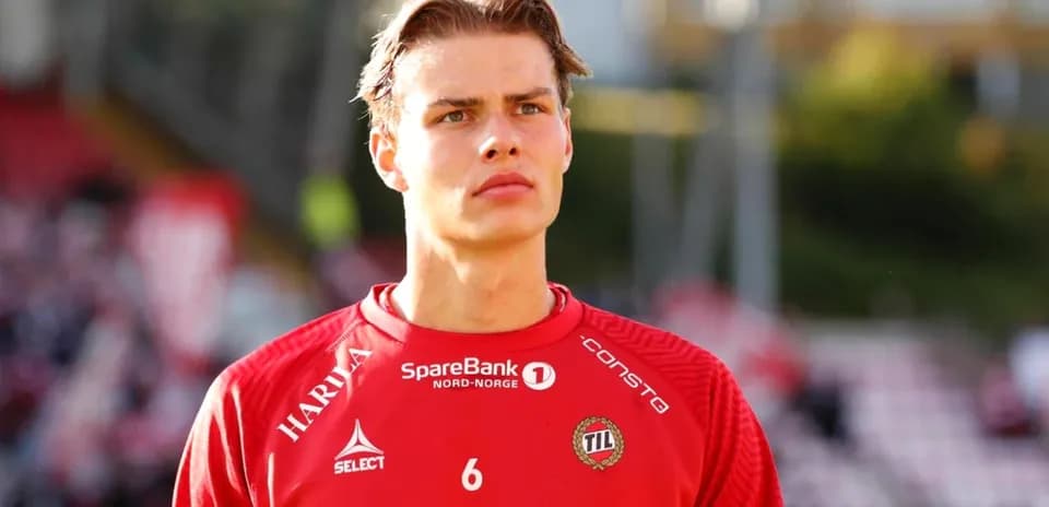 Player in red jersey during pre-match preparations