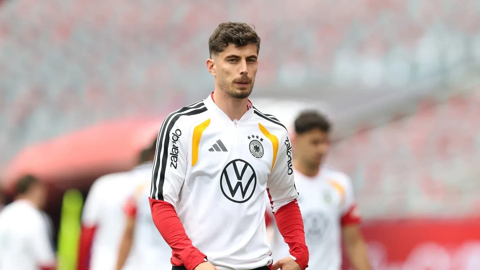 Player in Germany training kit walking on field