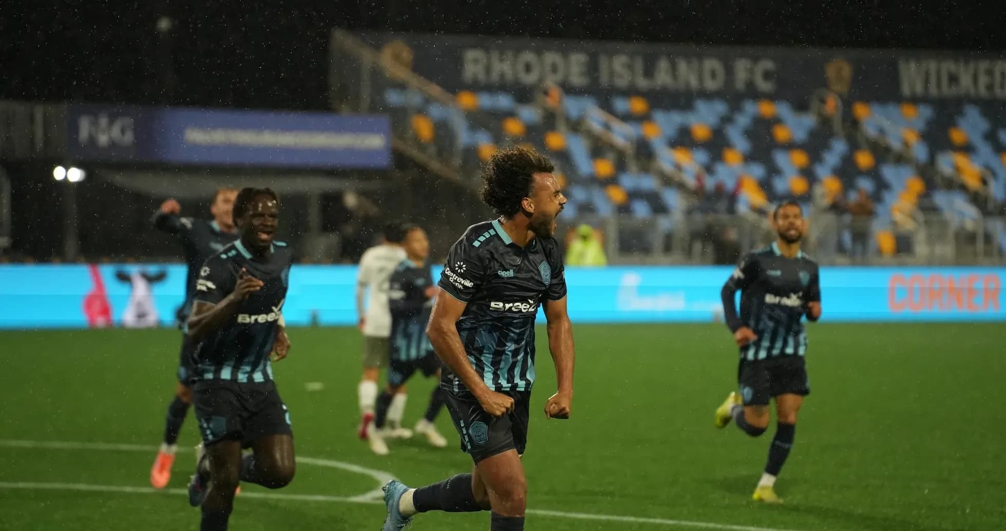 Rhode Island player celebrating goal during match