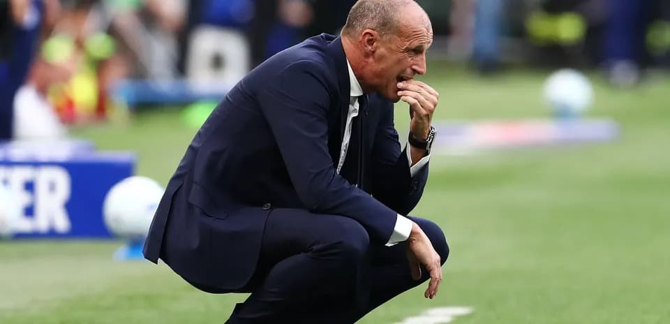 Coach kneeling on sideline during match