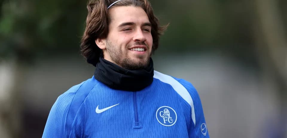 Player in blue training gear smiling outdoors