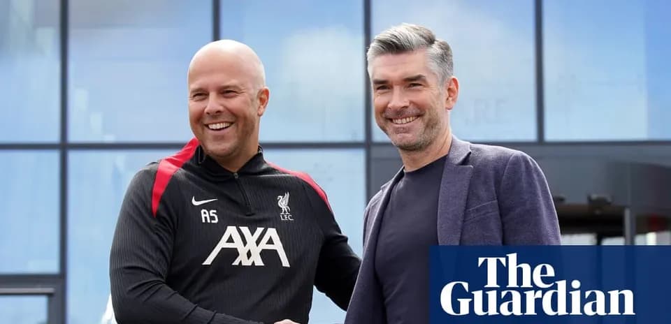 Two men shaking hands outside Liverpool FC facility